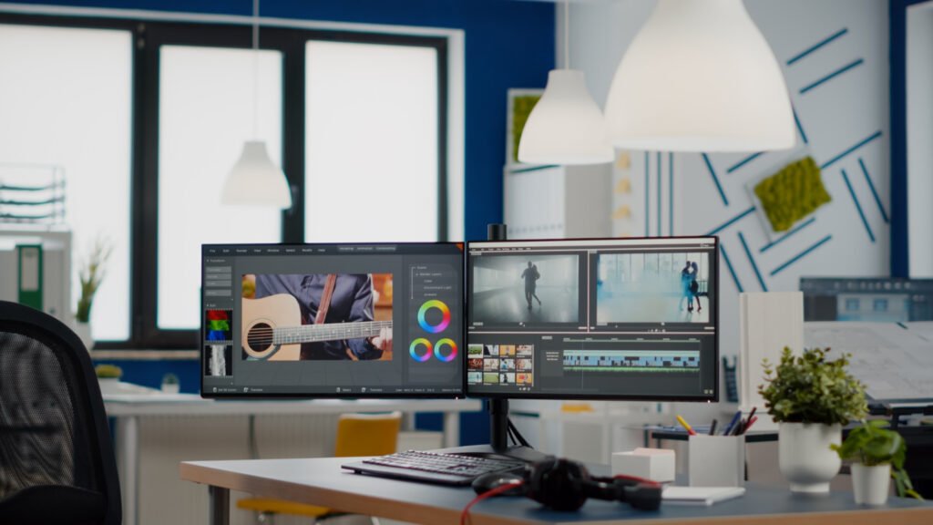 empty modern creative agency office with dual monitors setup with processing video film montage vide